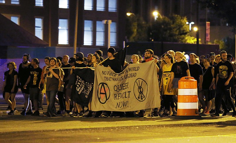 
              Protesters march on Broad Street late Sunday Aug. 13, 2017, in Richmond, Va. The group marched through the Fan District to the Lee Monument to Jackson Ward. The march was held a day after a white supremacist rally spiraled into deadly violence in Charlottesville, Va. (Shelby Lum/Richmond Times-Dispatch via AP)
            