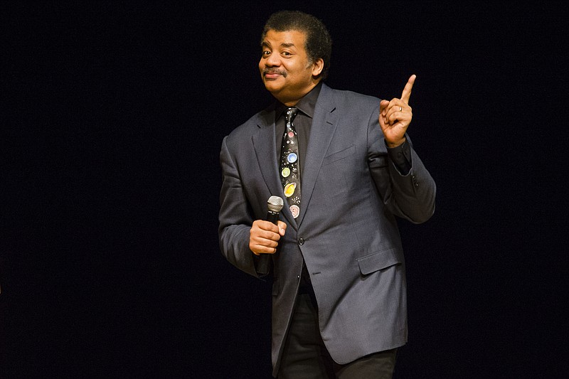 
              FILE - In this March 21, 2017 file photo, astrophysicist Neil deGrasse Tyson presents a lecture at the Morris Performing Arts Center in South Bend, Ind. Tyson has a suggestion for anyone with a view of next week's solar eclipse: Put down your smartphone and take in the phenomenon yourself. Tyson told an audience to "Experience this one emotionally, psychologically, physically," at New York's American Museum of Natural History on Monday Aug. 14, 2017. The Aug. 21 event will be the first total solar eclipse in 99 years to cross a coast-to-coast swath of the United States. (Michael Caterina/South Bend Tribune via AP, File)
            