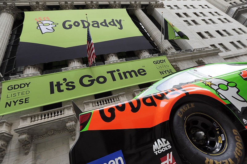
              FILE - In this April 1, 2015, file photo, GoDaddy signage and a race car announce the company's IPO, in front of the New York Stock Exchange in New York. GoDaddy announced on Aug. 13, 2017, that has given a prominent white nationalist website that promoted a Virginia rally that ended in deadly violence 24 hours to move its domain to another provider because the site has violated GoDaddy's terms of service.  (AP Photo/Richard Drew, File)
            