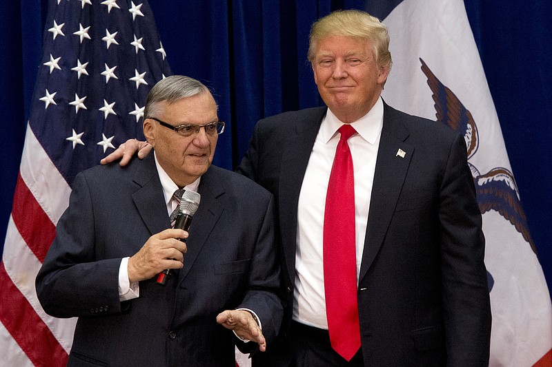 
              FILE - In this Jan. 26, 2016, photo, Republican presidential candidate Donald Trump is joined by Maricopa County, Ariz., Sheriff Joe Arpaio at a campaign event in Marshalltown, Iowa. President Trump says he may grant a pardon to former Sheriff Joe Arpaio following his recent conviction in federal court, prompting outrage among critics who say the move would amount to an endorsement of racism. (AP Photo/Mary Altaffer, File)
            