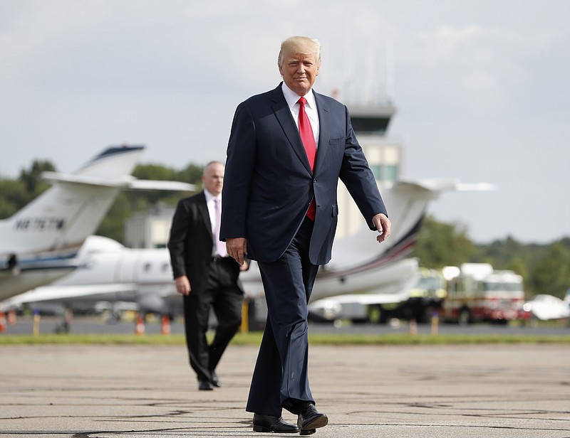 
              President Donald Trump walks from Marine One to board Air Force One at Morristown Municipal Airport, Monday, Aug. 14, 2017 in Morristown, N.J. Trump is traveling back to White House to sign an executive order at the White House and then later today travels to New York City. (AP Photo/Pablo Martinez Monsivais)
            