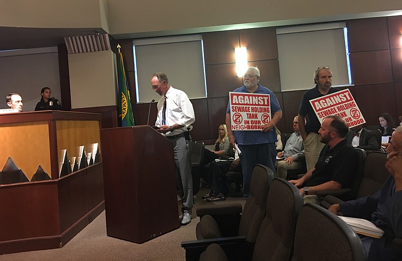 Fairfax Heights/Bagwell City resident Danny Grimmett, speaks to the Chattanooga City Council about DuPont area sewage storage tank plans in a recent meeting. Residents Mark Mullins and Ronnie McGill stand in support.