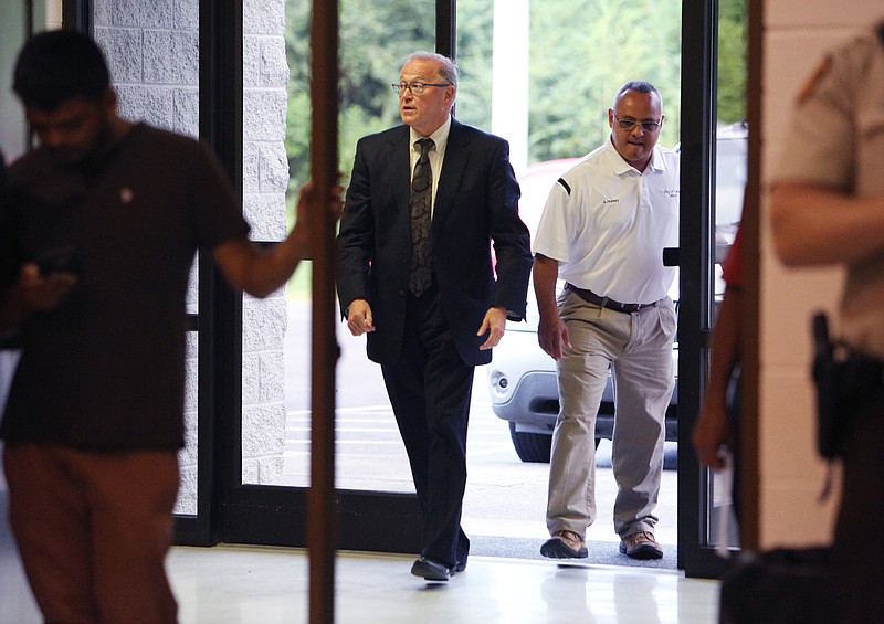 Varnell City Attorney Terry Miller and Mayor Anthony Hulsey walk into the Varnell City Gym before a canceled council meeting Tuesday, July 25, 2017, in Varnell, Ga. The Varnell City Council were meeting to decide whether or not to eliminate its police department, but there weren't enough council members in attendance for a quorum.