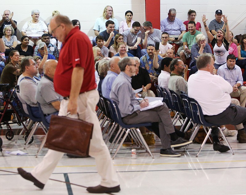 Citizens in attendance of a canceled council meeting cheer as Councilman Jan Pourquoi walks out Tuesday, July 25, 2017, at the Varnell City Gym in Varnell, Ga.