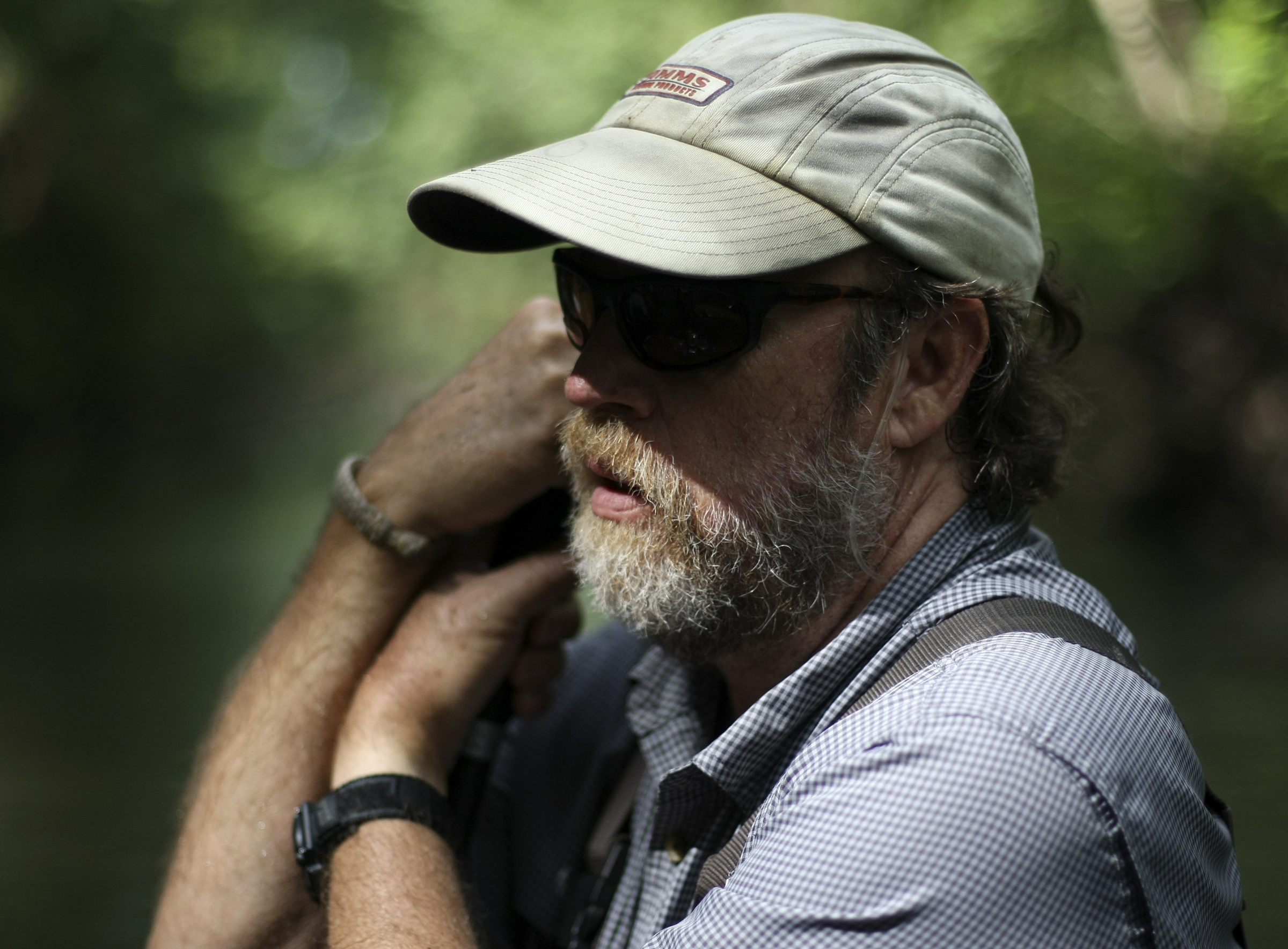 TVA Aquatic Zoologist David Matthews leans on his net during an aquatic survey in North Chickamauga Creek on Tuesday, Aug. 15, in Hixson, Tenn. Aquatic conservationists using a combination of tools, including a backpack electrofisher, to survey the health of area waterways and their inhabitants.