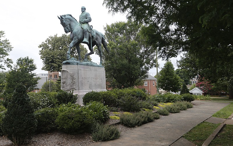 
              In this photo taken Aug. 14, 2017, the statue of Confederate General Robert E. Lee still stands in Lee park in Charlottesville, Va. Weeks before a statue of Robert E. Lee in Charlottesville, Virginia, became a flashpoint in the nation’s struggle over race and history, it already was a focus of emotional debate in the state’s Republican primary election.  (AP Photo/Steve Helber)
            