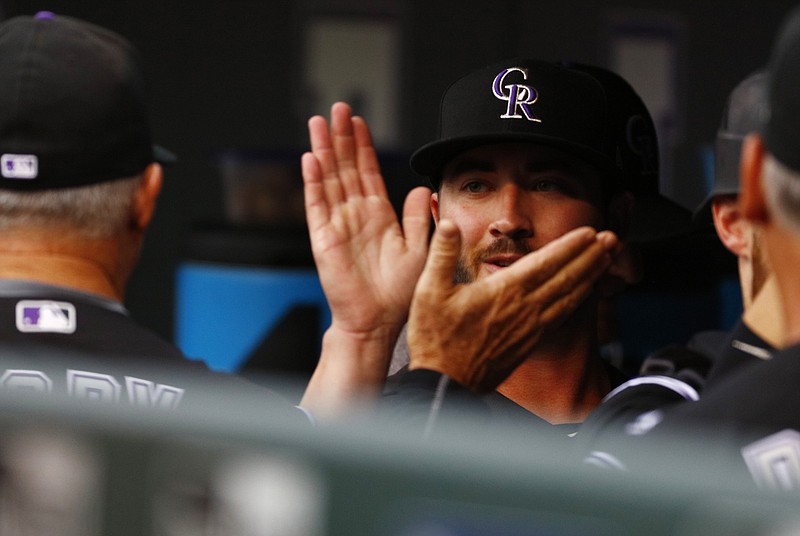 Colorado Rockies starting pitcher Chad Bettis high-fives teammates in the dugout before a baseball game against the Atlanta Braves, Monday, Aug. 14, 2017, in Denver. The game marks Bettis' first of the year after battling cancer. (AP Photo/Jack Dempsey)