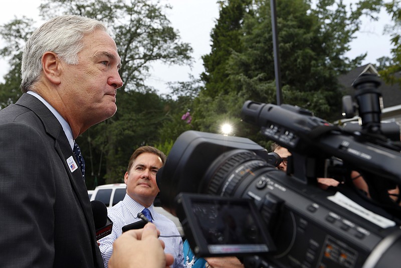 Senator Luther Strange talks with media after voting with his wife, Melissa, Tuesday, Aug. 15, 2017, in Homewood, Ala. Alabama voters are casting ballots Tuesday to select party nominees in the closely watched Senate race for the seat that belonged to Attorney General Jeff Sessions. (AP Photo/Butch Dill)