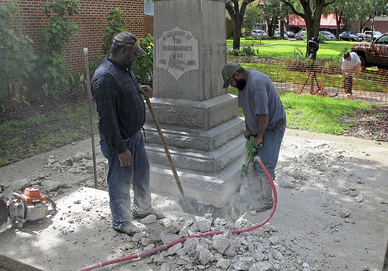 
              Workers begin removing a Confederate statue in Gainesivlle, Fla., Monday, Aug. 14, 2017. The statue is being returned to the local chapter of the United Daughters of the Confederacy, which erected the bronze statue in 1904. County officials said they did not know where the statue would be going. (AP Photo/Jason Dearen)
            