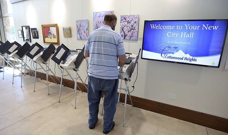 
              In this Friday, Aug. 11, 2017, photo, David Muir, a 58-year-old longtime Republican, casts his vote in Cottonwood Heights, Utah. Muir said that he cast his ballot early for John Curtis, because he thinks his experience running local government makes him more qualified than the other two. Three GOP candidates hoping to replace Jason Chaffetz in Congress will face off in a special election Tuesday, Aug. 15, 2017. (AP Photo/Rick Bowmer)
            