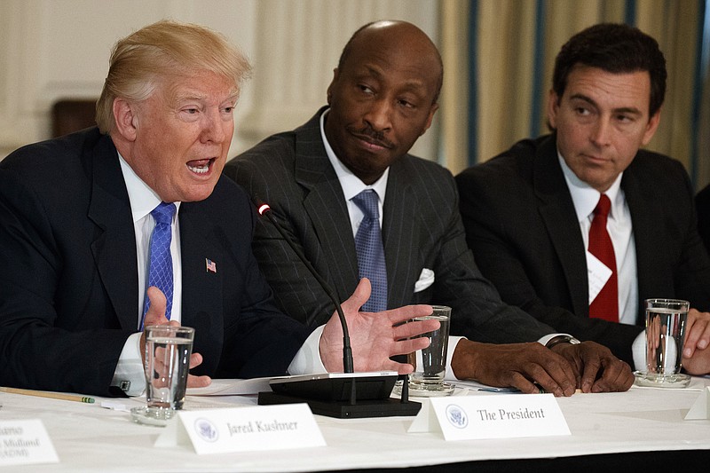 
              FILE - In this Thursday, Feb. 23, 2017, file photo, President Donald Trump, left, speaks during a meeting with manufacturing executives at the White House in Washington, including Merck CEO Kenneth Frazier, center, and Ford CEO Mark Fields. Frazier is resigning from the President’s American Manufacturing Council citing "a responsibility to take a stand against intolerance and extremism." Frazier's resignation comes shortly after a violent confrontation between white supremacists and protesters in Charlottesville, Va. Trump is being criticized for not explicitly condemning the white nationalists who marched in Charlottesville. (AP Photo/Evan Vucci, File)
            