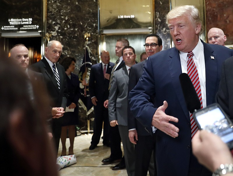 
              White House chief of staff John Kelly, left, watches as President Donald Trump speaks to the media in the lobby of Trump Tower, Tuesday, Aug. 15, 2017 in New York. (AP Photo/Pablo Martinez Monsivais)
            