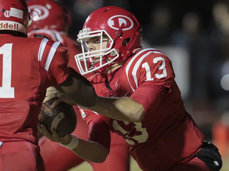 Staff Photo by Dan Henry / The Chattanooga Times Free Press- 12/2/16. Dalton quarter back JP Tighe (13) hands the ball off to Kyric McGowan (11) while paying Valdosta during the first half of the GHSA Class 6A semifinal playoff game at Harmon Fiend on Friday, December 2, 2016. 