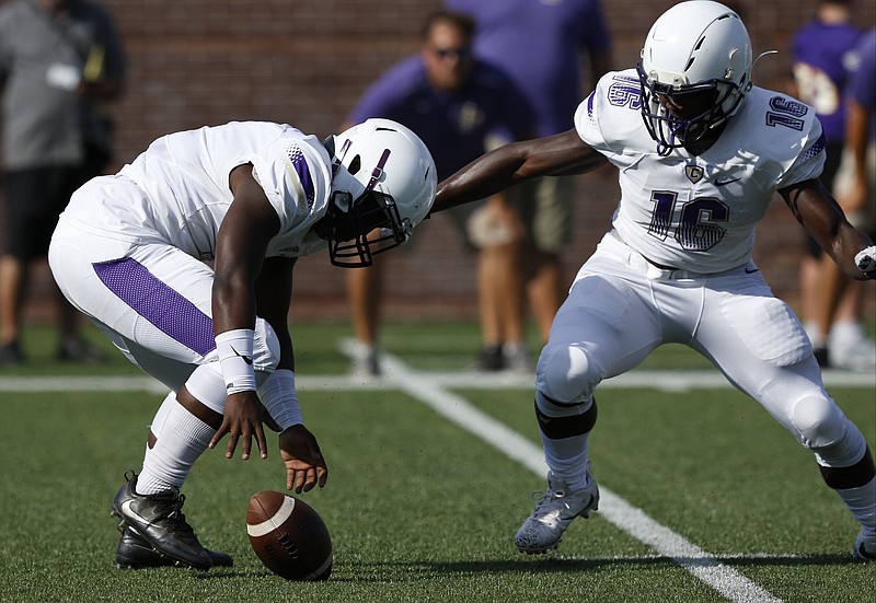 Central quarterback Jaheim Jones, left, and teammate Michael McGhee go for Jones's fumbled ball during their Best of Preps prep football jamboree scrimmage at Finely Stadium on Saturday, Aug. 12, 2017, in Chattanooga, Tenn.