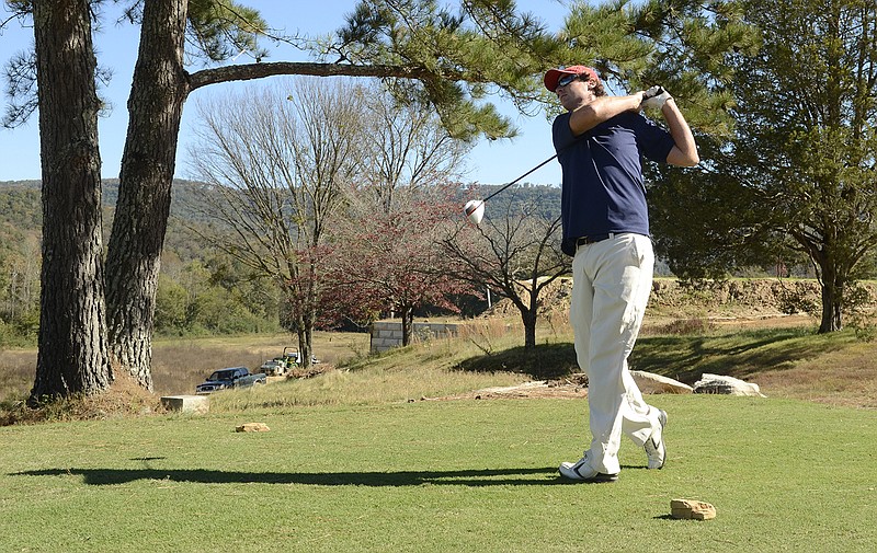 Course designer and builder Rob Collins tees off at Sweetens Cove Golf Club in South Pittsburg on Oct. 22, 2014.