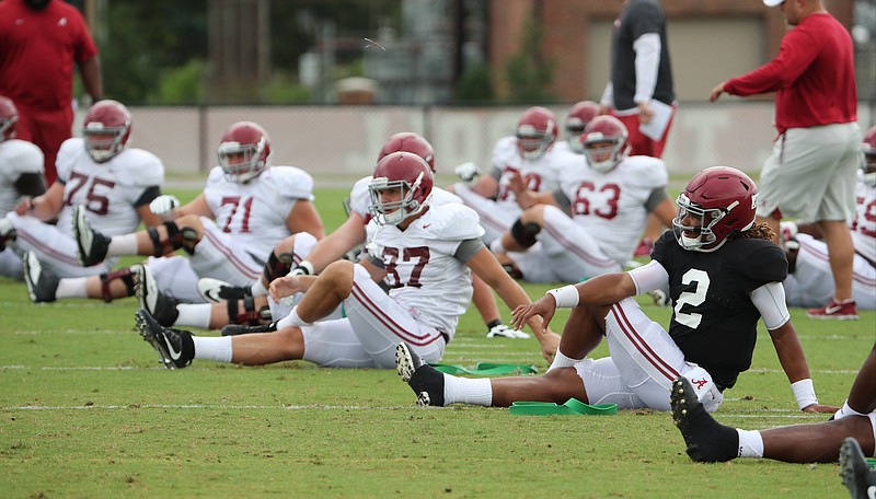 Alabama quarterback Jalen Hurts (2) and other offensive players stretch before a practice this week in Tuscaloosa.