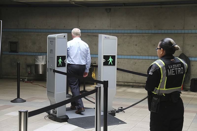 
              Chris McLaughlin, a vice president with Evolv Technology, test the company's body scanner at Union Station subway station in Los Angeles Wednesday, Aug. 16, 2017. Passengers boarding subway trains in Los Angeles may soon be shuffled through airport-style body scanners that are aimed to detect firearms and explosives. A two-day pilot program by the Los Angeles Metropolitan Transportation Authority, Metro began Wednesday at Union Station. Officials say the machines can scan about 600 people per hour. (AP Photo/Mike Balsamo)
            