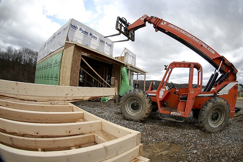 
              In this Wednesday, March 1, 2017, photo, a forklift is parked in front of one of the houses under construction in a housing plan in Zelienople, Pa. On Wednesday, Aug. 16, 2017, the Commerce Department reports on U.S. home construction in July. (AP Photo/Keith Srakocic)
            