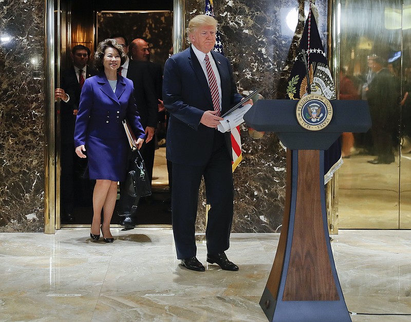 
              President Donald Trump walks out of the elevator to speak in the lobby of Trump Tower, Tuesday, Aug. 15, 2017 in New York. Walking out with Trump are Transportation Secretary Elaine Chao, Treasury Secretary Steve Mnuchin, and National Economic Council Director Gary Cohn. (AP Photo/Pablo Martinez Monsivais)
            