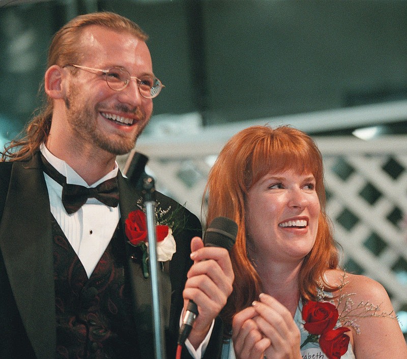 
              FILE - In this June 13, 1998 file photo, David Weinlick and Elizabeth Runze speak to the audience after Runze was picked to be Weinlick's bride at Mall of America in Bloomington, Minn. Weinlick's family and friends picked Runze from a group of 23 possible brides less than two hours before the wedding. The Minnesota couple who began their life together through an arranged marriage nearly 20 years ago are about to renew their vows. The ceremony on Friday, Aug. 18, 2017 will again be at the Mall of America. (AP Photo/Scott Cohen, File)
            
