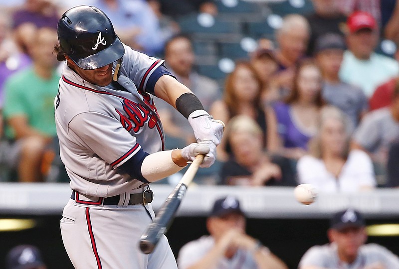 Atlanta Braves' Dansby Swanson connects for a two run double off Colorado Rockies starting pitcher Kyle Freeland during the second inning of a baseball game Tuesday, Aug. 15, 2017, in Denver. (AP Photo/Jack Dempsey)
