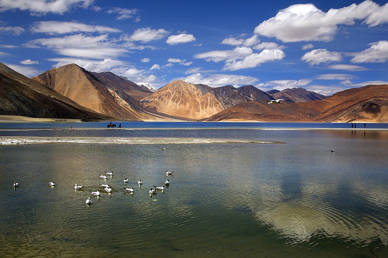 
              In this Sunday, June 17, 2016, photo, an Indian tourist rides on a horse back at the Pangong lake high up in Ladahak region of India. The Chinese soldiers hurled stones while attempting to enter Ladakh region near Pangong Lake on Tuesday but were confronted by Indian soldiers, said a top police officer. The officer said Indian soldiers retaliated but neither side used guns. There was immediately no comment from China. (AP Photo/Manish Swarup)
            