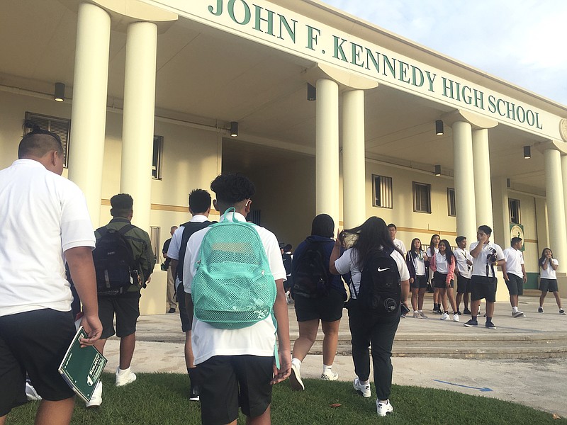 
              Students arrive at John F. Kennedy High School in Tamuning, Guam, Thursday, Aug. 17, 2017. Public schools in Guam opened Thursday, a sign of normalcy returned to the Pacific island after a week of living under threat of missile attack by North Korea. (AP Photo/Tassanee Vejpongsa)
            