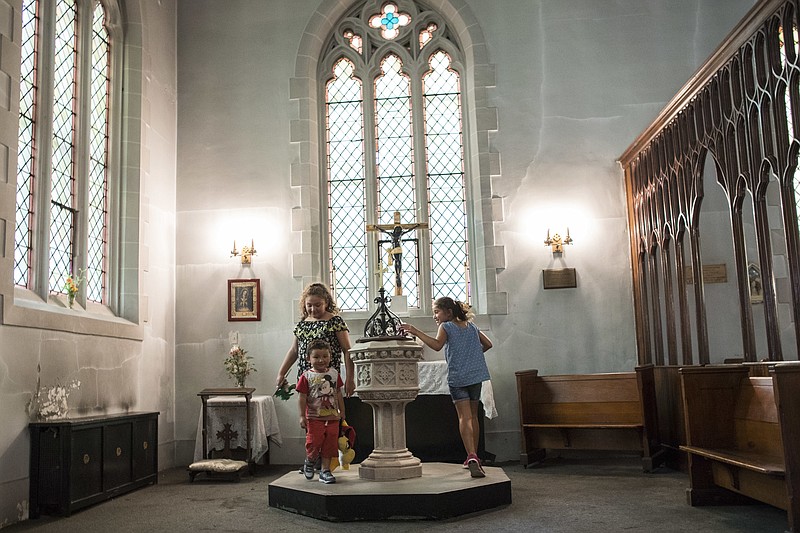 
              Amanda Morales' children Daniela Carvajal, right, Dulce Carvajal, left, and David Carvajal foreground play inside the Holyrood Church, Thursday, Aug. 17, 2017, in the Washington Heights neighborhood of Manhattan. Morales who is originally from Guatemala and has lived without authorization in the U.S. since 2004 has taken sanctuary at the church. (AP Photo/Mary Altaffer)
            