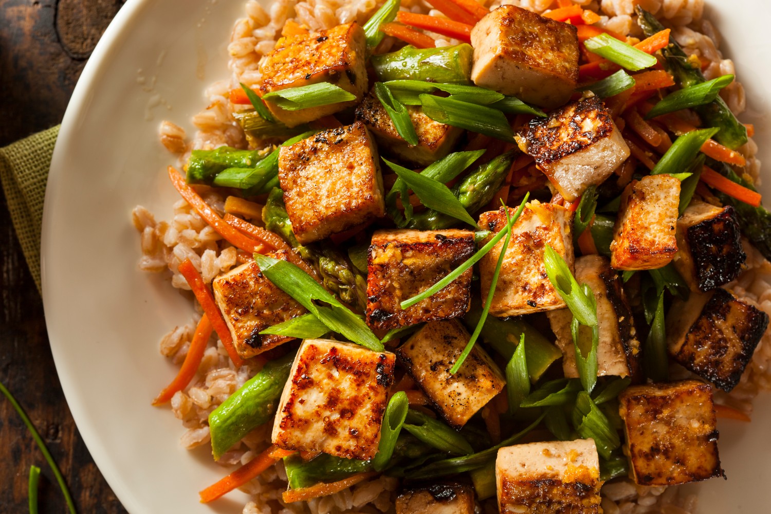 Tofu is the vegetarian standby that is perfect for simple additions to meals. Silken tofu can be added to a shake for a boost of protein, while firmer blocks can be marinated to taste for any dish, like stir-fry.