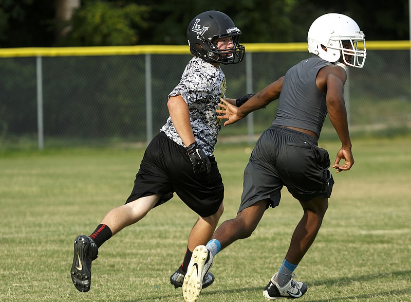 Lookout Valley's Tanner Hoge, left, covers a Brainerd receiver during a 7-on-7 scrimmage.