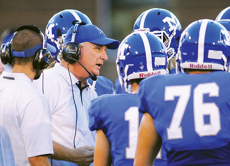 McCallie coach Ralph Potter talks to his offense during a game.