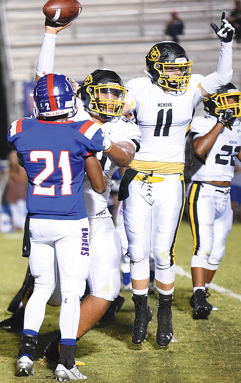 McMinn County's Will Wright (11) celebrates alongside Xayvier Beckingham after the Cherokees recovered a fumble.