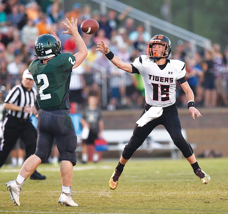 Meigs County quarterback Aaron Swafford (19) fires a pass past Silverdale Baptist's Hayden Spencer during a game last season. Swafford is back after starting all 12 games as a freshman last season.