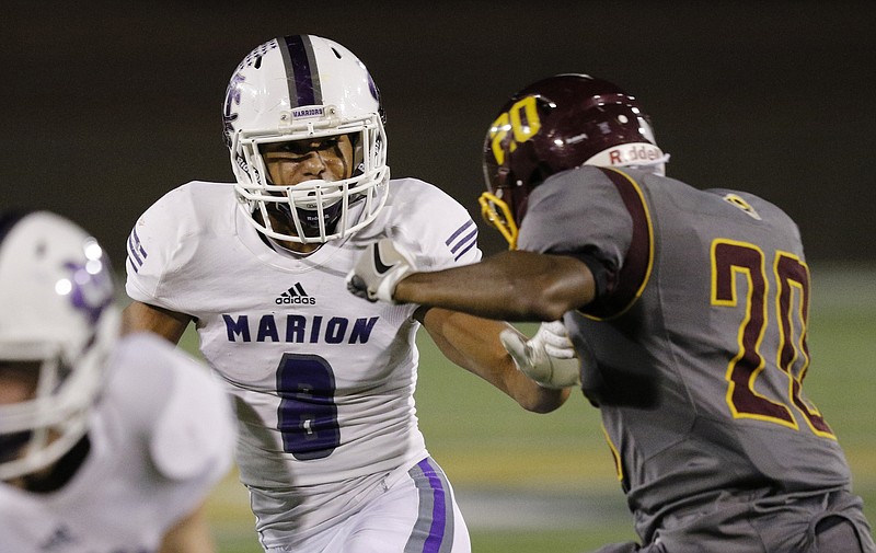 Marion County running back Jacob Saylors, with ball, looks to slip past Tyner's defense.