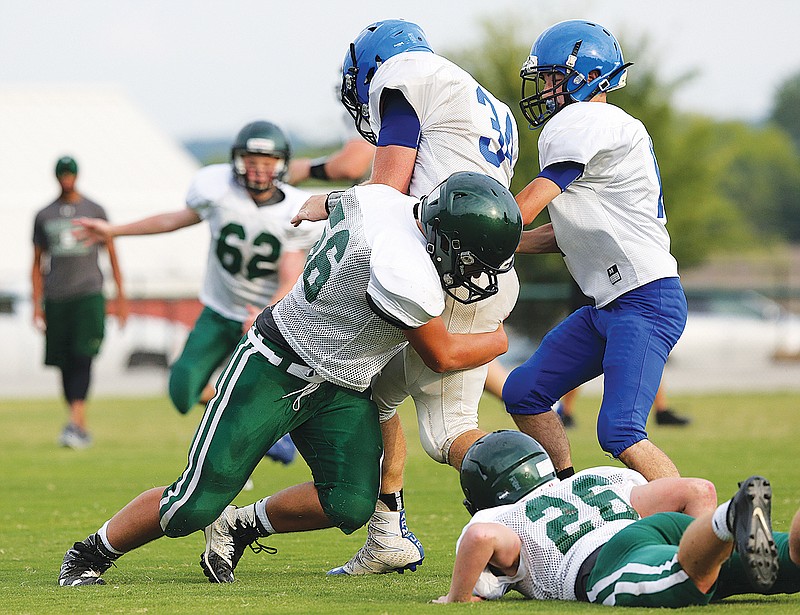 Silverdale Baptist's Ben Bambrey makes the tackle during a scrimmage.
