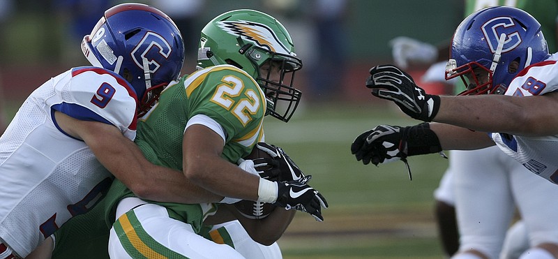 Cleveland's Caleb Flickner (78) lunges in to help teammate Logan Stutzman (9) stop Rhea County's Christian Simon (22) for no gain at Rhea County's Eagle Stadium on Friday, Aug. 18, in Evensville, Tenn.

