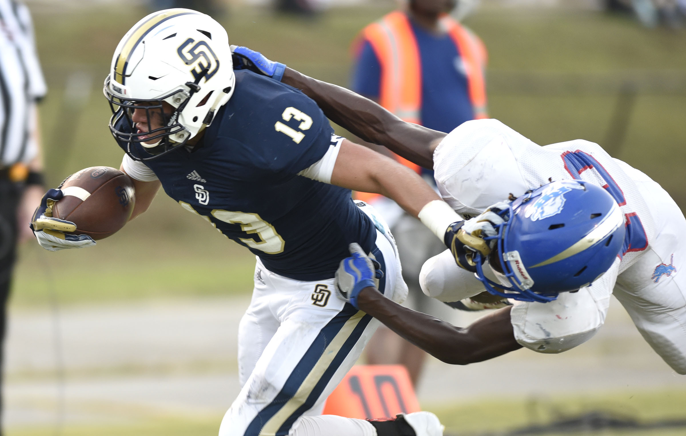 Soddy-Daisy's Ty Boeck (13) shakes off Red Bank's David Cosby (10) to score the Trojan's first touchdown. The Red Bank Lions visited the Soddy-Daisy Trojans in TSSAA football action at Soddy-Daisy High School on August 18, 2017.