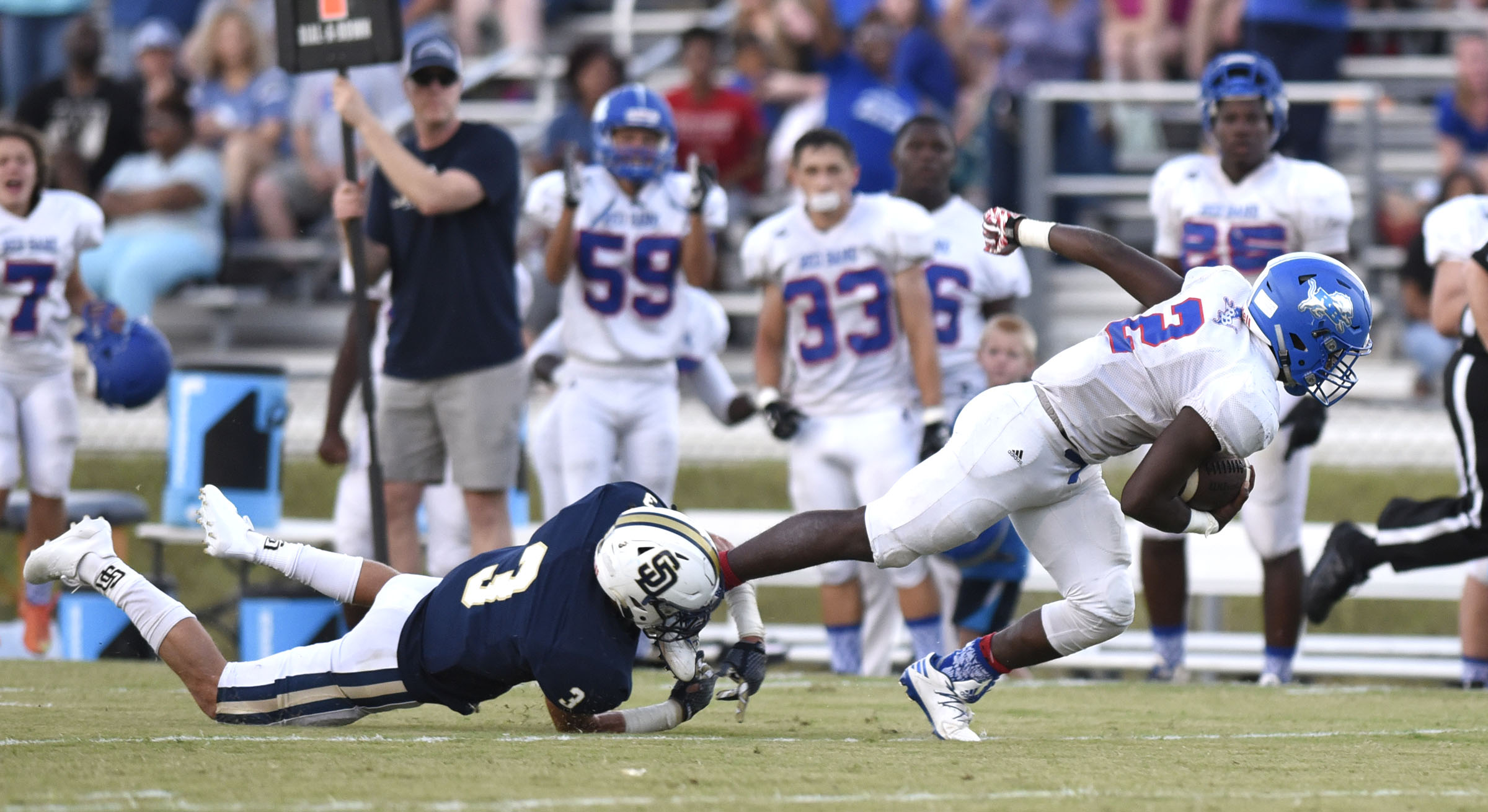 Red Bank's Zay Brown (2) dives for yardage as Soddy-Daisy's Brandon Davis (3) trips him up. The Red Bank Lions visited the Soddy-Daisy Trojans in TSSAA football action at Soddy-Daisy High School on August 18, 2017.