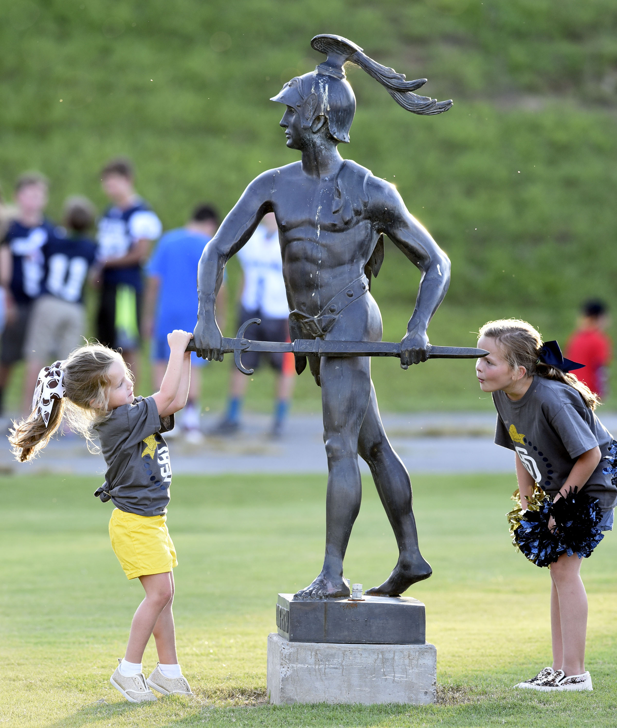 Two tiny Soddy-Daisy Cheerleaders inspect the statue of the Trojan. The Red Bank Lions visited the Soddy-Daisy Trojans in TSSAA football action at Soddy-Daisy High School on August 18, 2017.