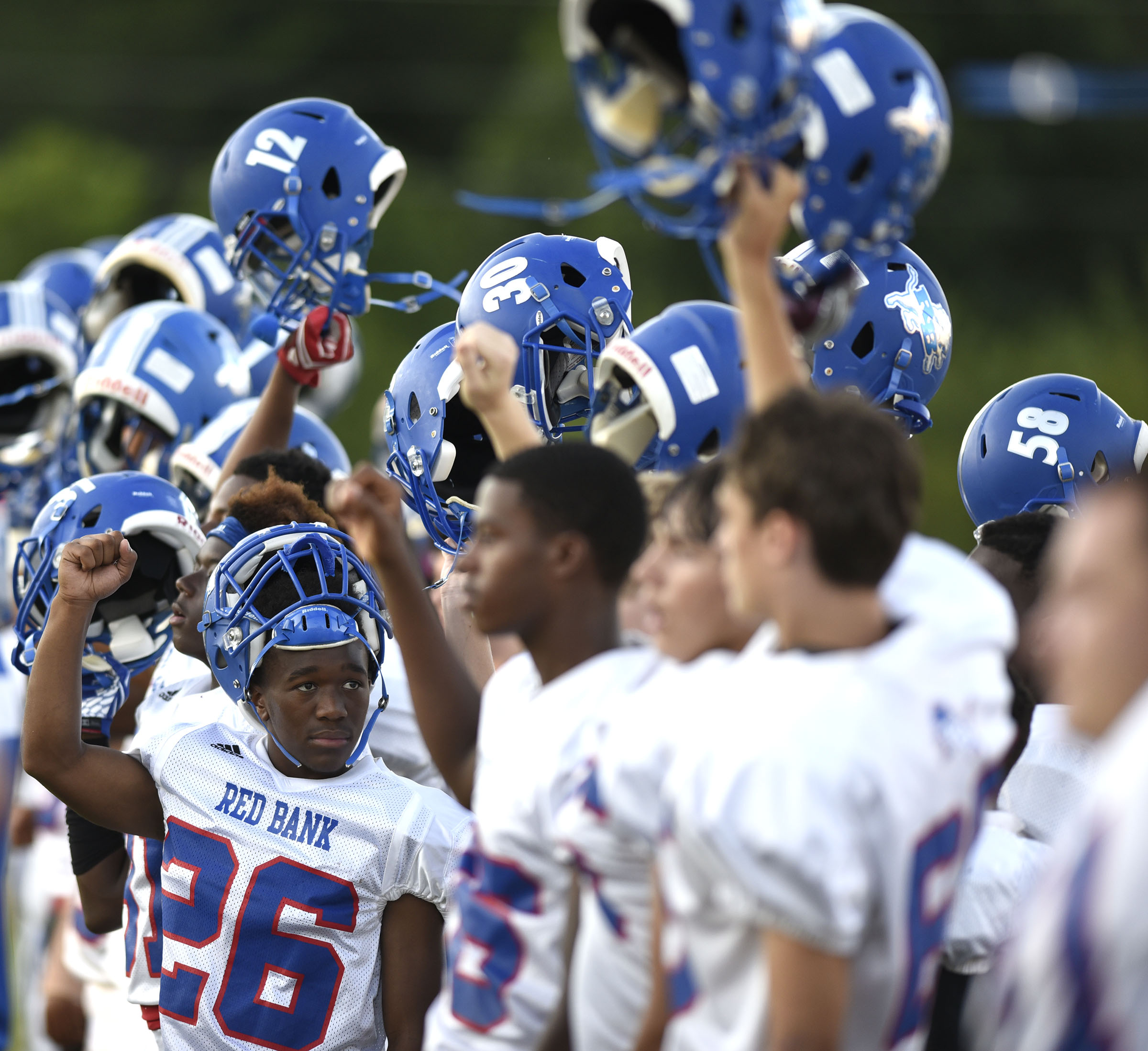 The Red Bank bench raises their helmets at the kickoff. The Red Bank Lions visited the Soddy-Daisy Trojans in TSSAA football action at Soddy-Daisy High School on August 18, 2017.