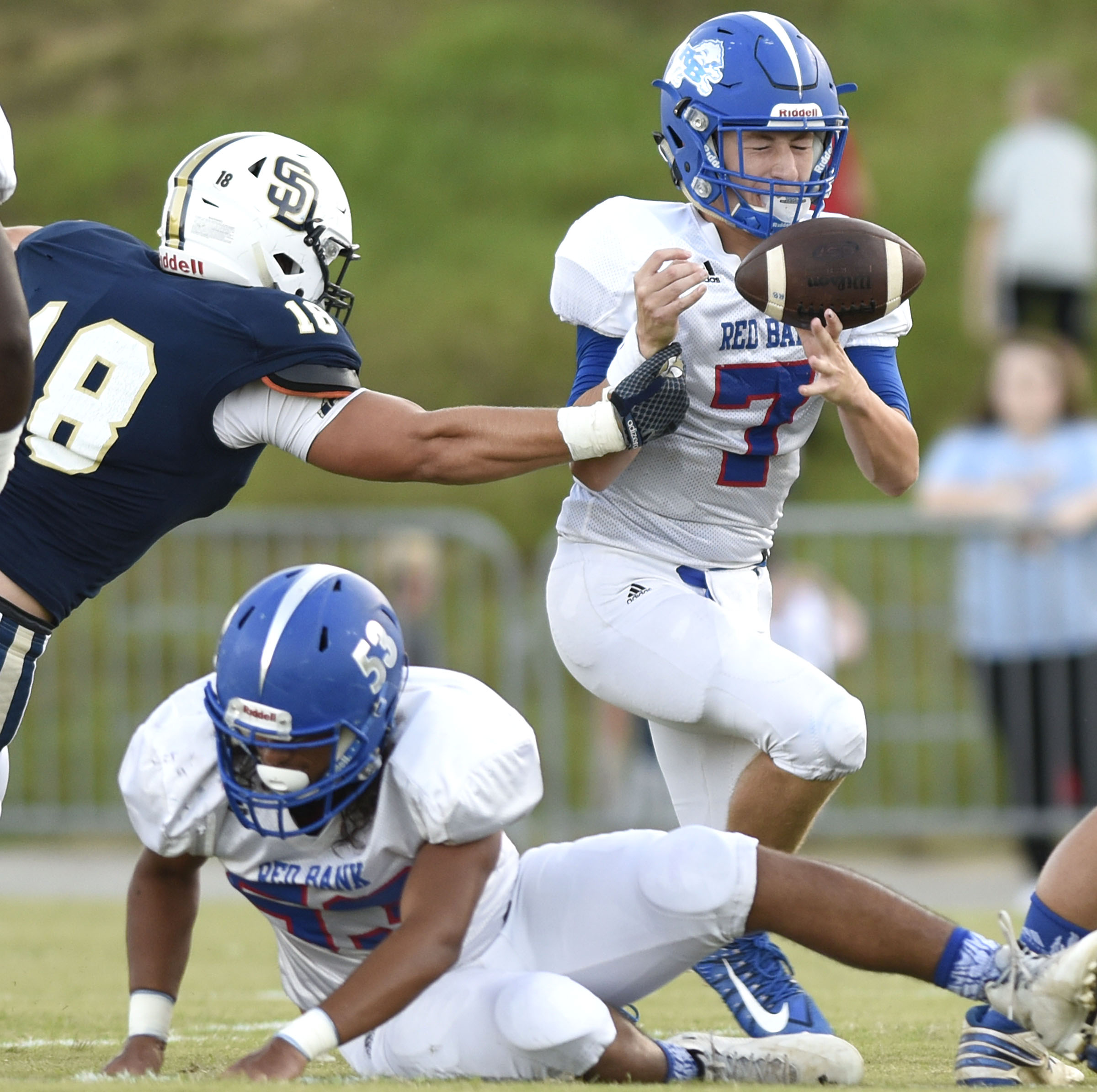 Soddy-Daisy's Jake Seeger (18) strips the ball from Red Bank quarterback Madox Wilkey (7). Red Bank recovered the fumble. The Red Bank Lions visited the Soddy-Daisy Trojans in TSSAA football action at Soddy-Daisy High School on August 18, 2017.