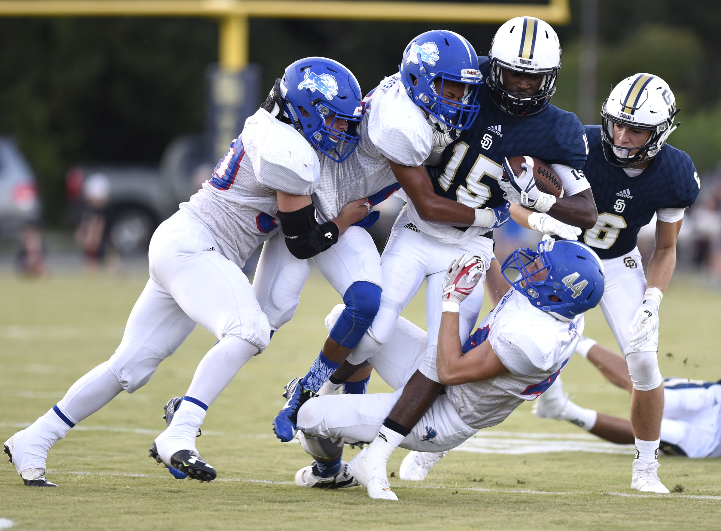 Three Lion defenders bring down Soddy-Daisy's Jarvis Smith (15). The Red Bank Lions visited the Soddy-Daisy Trojans in TSSAA football action at Soddy-Daisy High School on August 18, 2017.