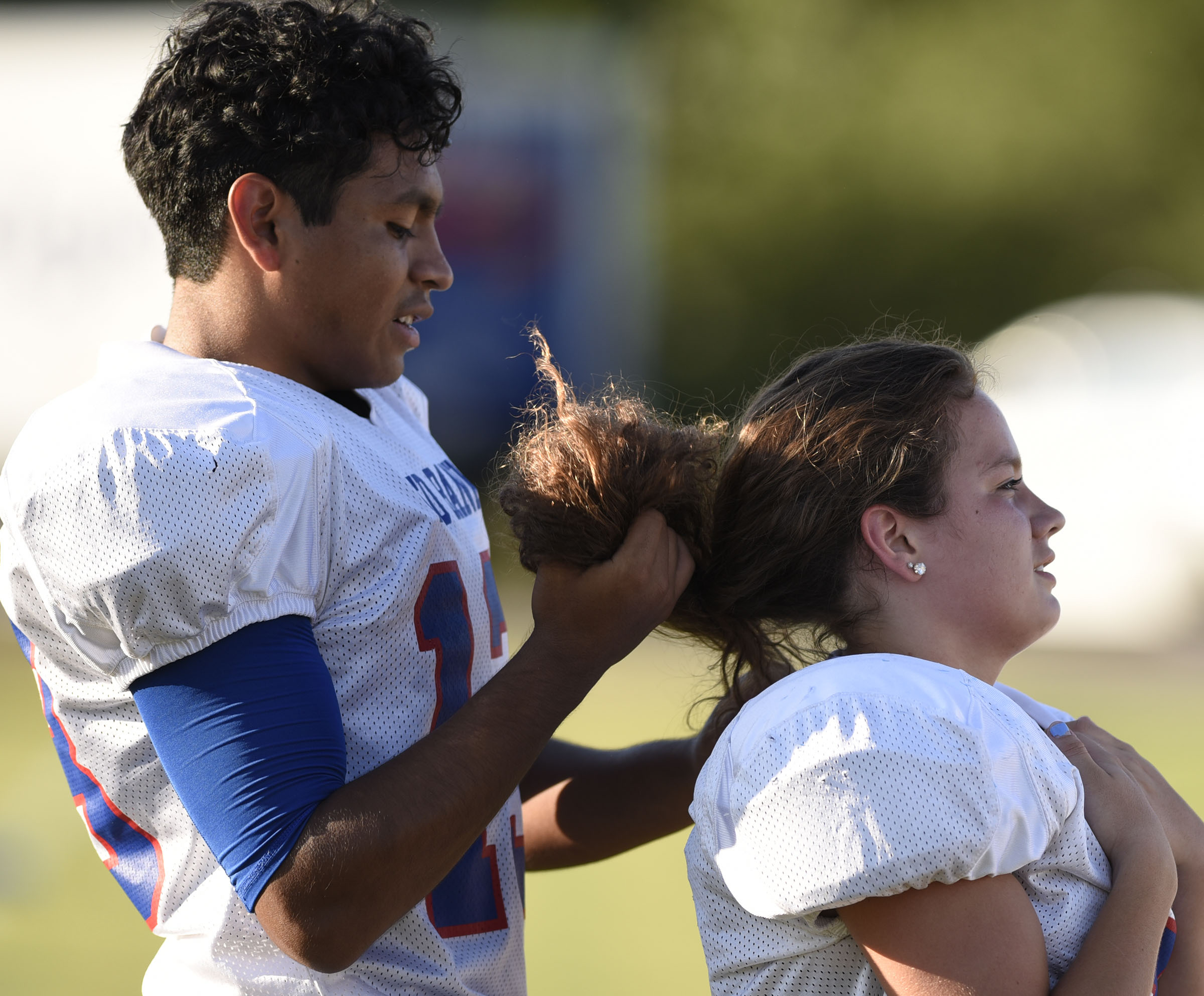 Red Bank kicker Braulio Velazquez (13) ties a fellow kicker's hair before the game. The Red Bank Lions visited the Soddy-Daisy Trojans in TSSAA football action at Soddy-Daisy High School on August 18, 2017.
