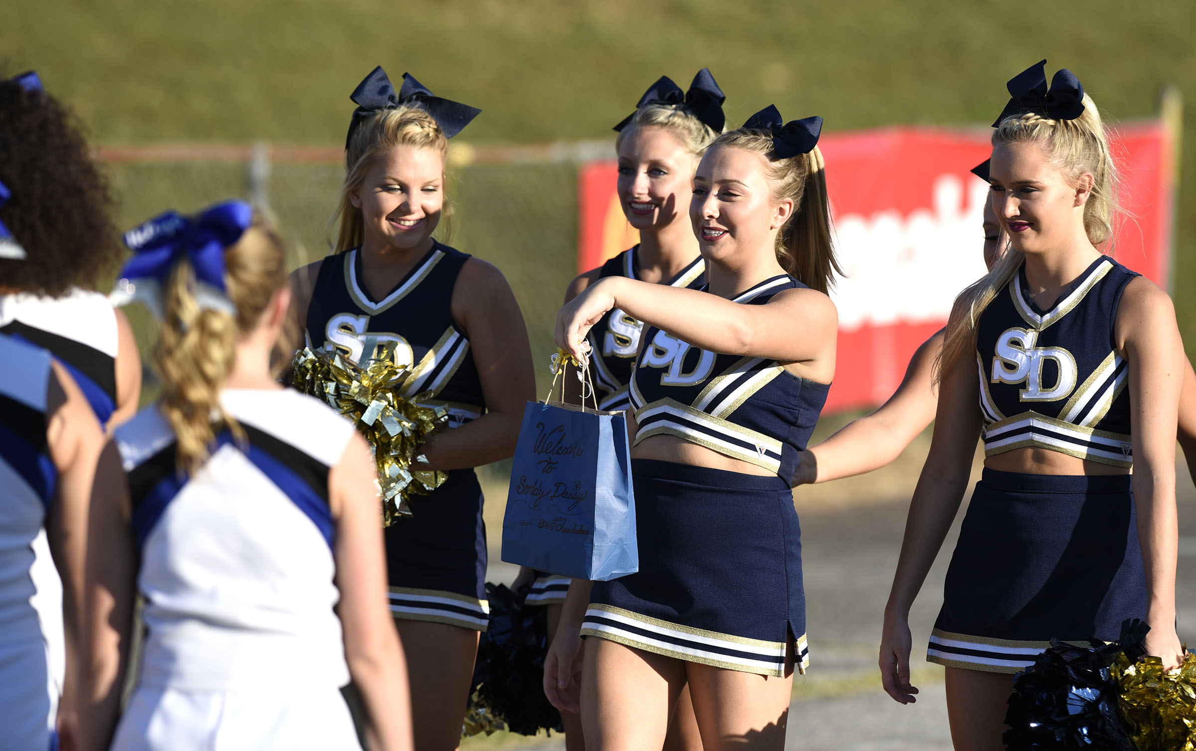 The Soddy-Daisy cheerleaders present a gift to their Red Bank counterparts. The Red Bank Lions visited the Soddy-Daisy Trojans in TSSAA football action at Soddy-Daisy High School on August 18, 2017.