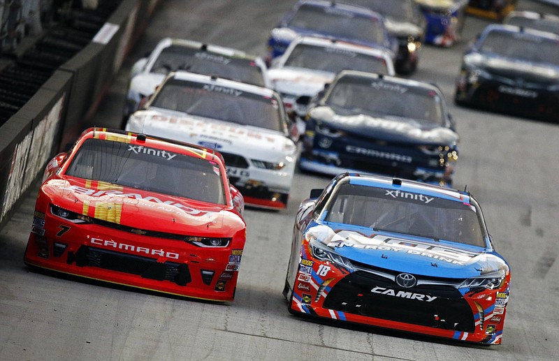 
              Justin Allgaier (7) and Kyle Busch (18) vie for the lead during the NASCAR Xfinity Series auto race, Friday, Aug. 18, 2017 in Bristol, Tenn. (AP Photo/Wade Payne)
            