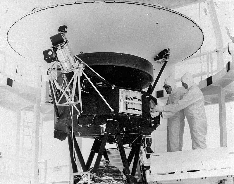 
              FILE - In this Aug. 4, 1977 photo provided by NASA, the "Sounds of Earth" record is mounted on the Voyager 2 spacecraft in the Safe-1 Building at the Kennedy Space Center, Fla., prior to encapsulation in the protective shroud. Sunday, Aug. 20, 2017 marks the 40th anniversary of NASA's launch of Voyager 2, now almost 11 billion miles distant. (AP Photo/NASA)
            