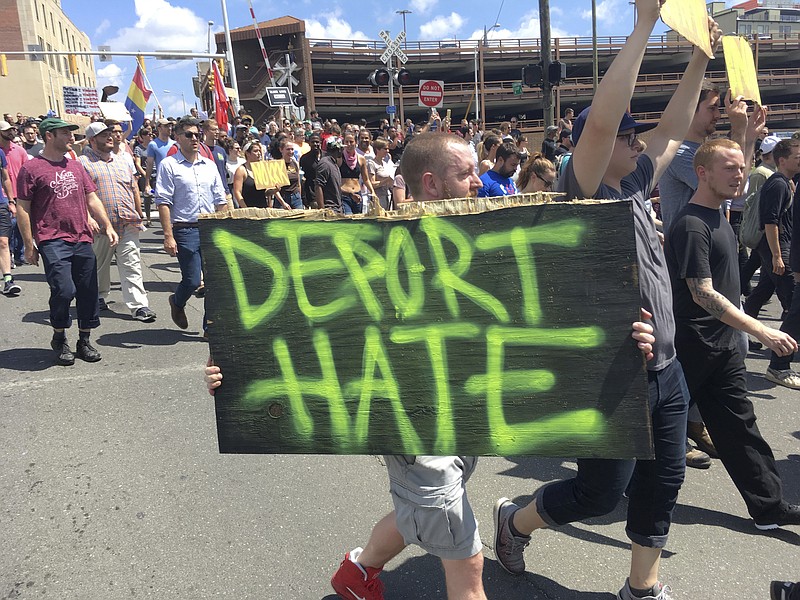 People march in the streets of Durham protesting against a possible march by the Ku Klux Klan, Friday, Aug. 18, 2017, in Durham, N.C. Hundreds of anti-racist demonstrators gathered in a North Carolina city in response to rumors of a white supremacist march. The sheriff had issued a statement that he was investigating the rumors, but no gathering of white supremacists was apparent by midafternoon. However, officers blocked streets and businesses closed. (AP Photo/Jonathan Drew)

