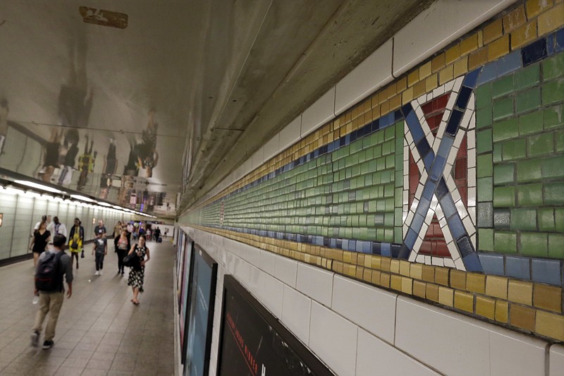 
              The mosaic tile design meant to represent Times Square's status as the "Crossroads of the World" is part of the subway station's border, in New York, Friday, Aug. 18, 2017. Transit officials have decided to alter subway tiles at the station that have a design that's been compared to the Confederate flag, to make it "crystal clear" that they don't depict the flag. (AP Photo/Richard Drew)
            