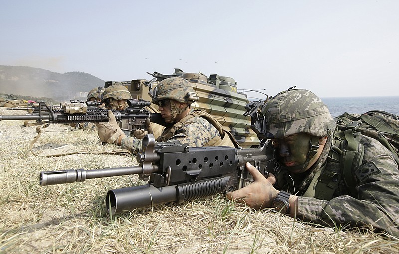 
              FILE - In this March 30, 2015, file photo, Marines of South Korea, right and the U.S aim their weapons near amphibious assault vehicles during the U.S.-South Korea joint landing military exercises as a part of the annual joint military exercise Foal Eagle between South Korea and the United States in Pohang, South Korea. America’s annual joint military exercises with South Korea always frustrate North Korea. The war games set to begin Monday, Aug. 21, 2017 may hold more potential to provoke than ever, given President Donald Trump’s “fire and fury” threats and Pyongyang’s as-yet-unpursued plan to launch missiles close to Guam. (AP Photo/Lee Jin-man, File)
            
