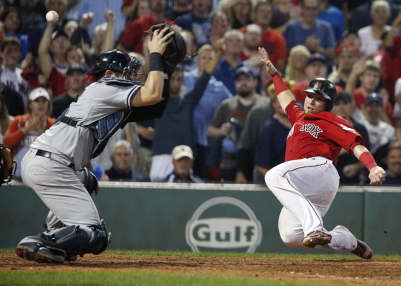 
              Boston Red Sox's Christian Vazquez, right, scores as the throw goes by New York Yankees' Austin Romine on a two-run single by Jackie Bradley Jr. during the eighth inning of a baseball game, Friday, Aug. 18, 2017, in Boston. (AP Photo/Michael Dwyer)
            